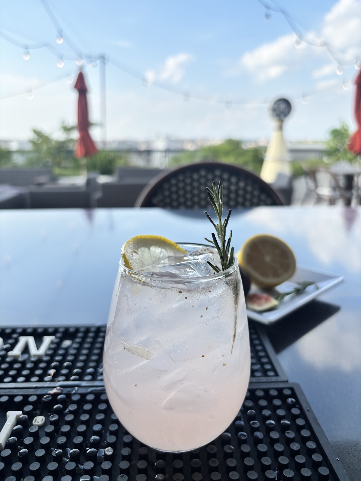 Golden-hour mocktail on the CityBar DC rooftop beneath string lights